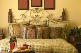 bedroom with gold color bedding and gold colored walls