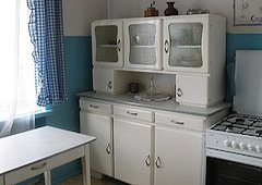 shaker kitchen with blue and white walls and curtains